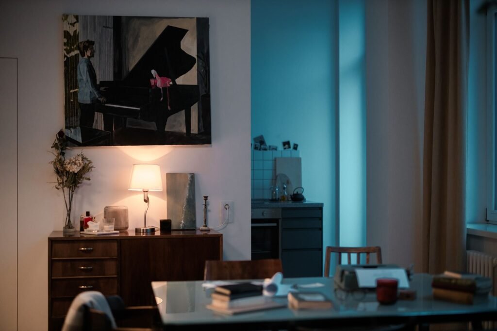 A modest living room with warm lamp light and a tidy side table